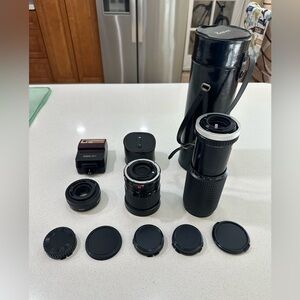 Canon Black and Silver Lenses and flash. “Sold as is”.